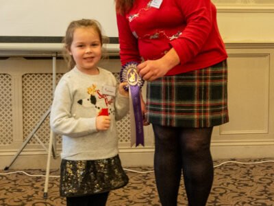 Liz Brown presenting Amelia Mingham with her Showing Rosette